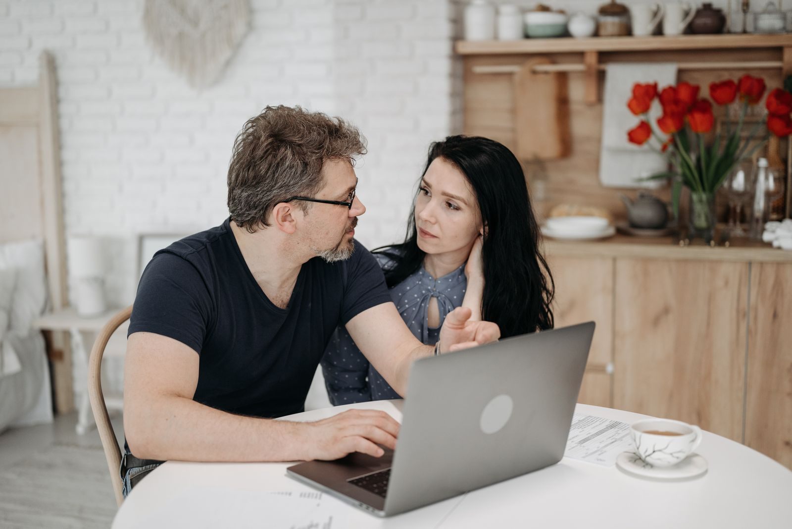 Couple reviewing travel options on a laptop
