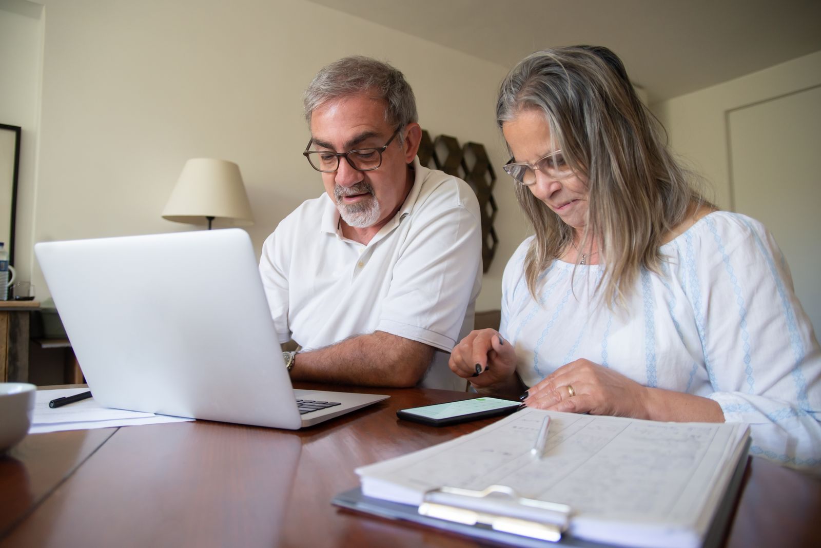 Couple comparing cruise options on a laptop
