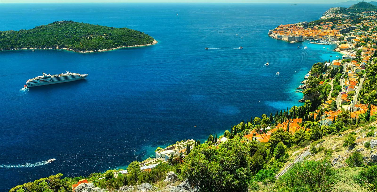 Cruise ship off a rugged Mediterranean coast